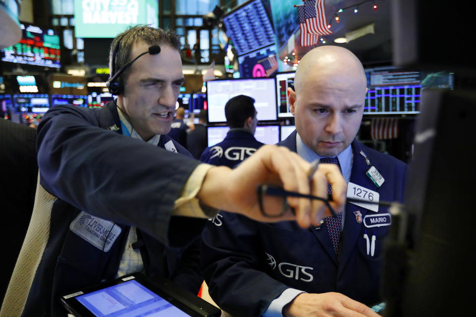 Trader Gregory Rowe, left, and specialist Mario Picone work on the floor of the New York Stock Exchange, Thursday, Dec. 27, 2018. Wall Street's wild Christmas week goes on, with the Dow Jones Industrial Average slumping 300 points at the open Thursday, a day after notching its biggest-ever point gain. (AP Photo/Richard Drew)