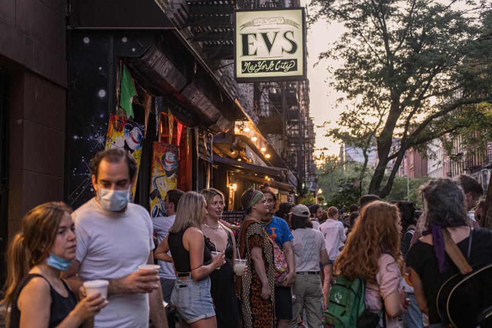 People drink outside a bar during the reopening phase following the coronavirus disease (COVID-19) outbreak in the East Village neighborhood in New York U.S., June 12, 2020. Picture taken June 12, 2020. REUTERS/Jeenah Moon