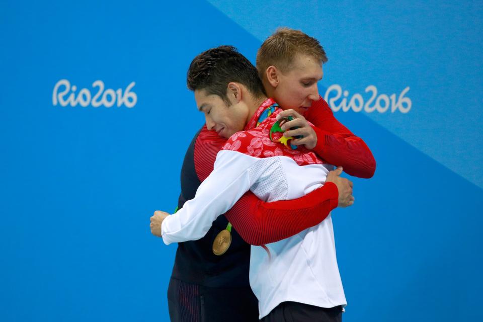 <p>(L-R) Silver medalist Chase Kalisz of the United States and gold medal medalist Kosuke Hagino of Japan embrace during the medal ceremony for the Final of the Men’s 400m Individual Medley on Day 1 of the Rio 2016 Olympic Games at the Olympic Aquatics Stadium on August 6, 2016 in Rio de Janeiro, Brazil. (Photo by Adam Pretty/Getty Images) </p>