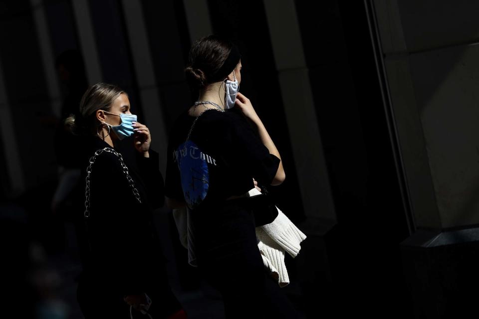 Young women wearing face masks as they walk trough downtown Munich, Germany on Sept. 22, 2020.<span class="copyright">Matthias Schrader—AP</span>