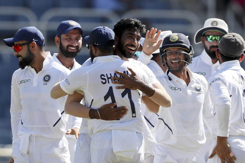 India's Jasprit Bumrah is congratulated by teammates for his hat-trick wicket by the dismissal of West Indies' Roston Chase during day two of the second Test cricket match at Sabina Park cricket ground in Kingston, Jamaica Saturday, Aug. 31, 2019. (AP Photo/Ricardo Mazalan)