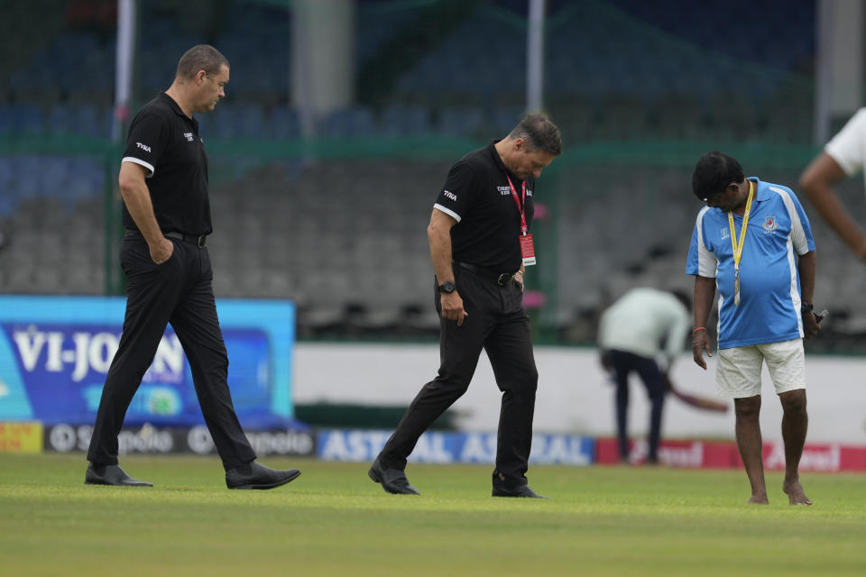 The pitch curator Shiv Kumar, right, in blue shirt, and match officials inspect the playing area on the third day of the second cricket test match between Bangladesh and India in Kanpur, India, Sunday, Sept. 29, 2024. (AP Photo/Ajit Solanki)