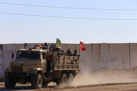 Iraqi army members ride in a military vehicle in Bartila, Iraq December 7, 2016. REUTERS/Alaa Al-Marjani