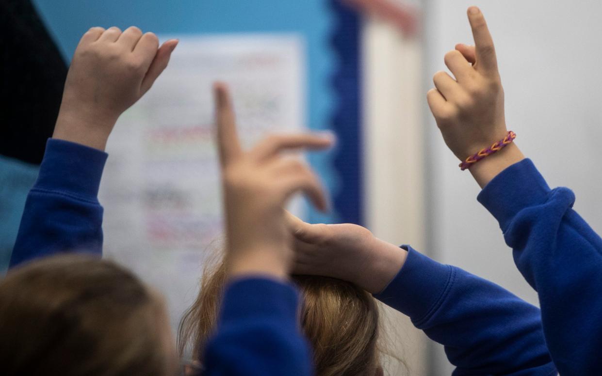 children raising their hands