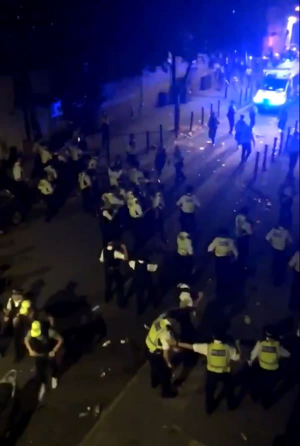 Video footage showed police officers being chased and having bottles thrown at them. (PA)