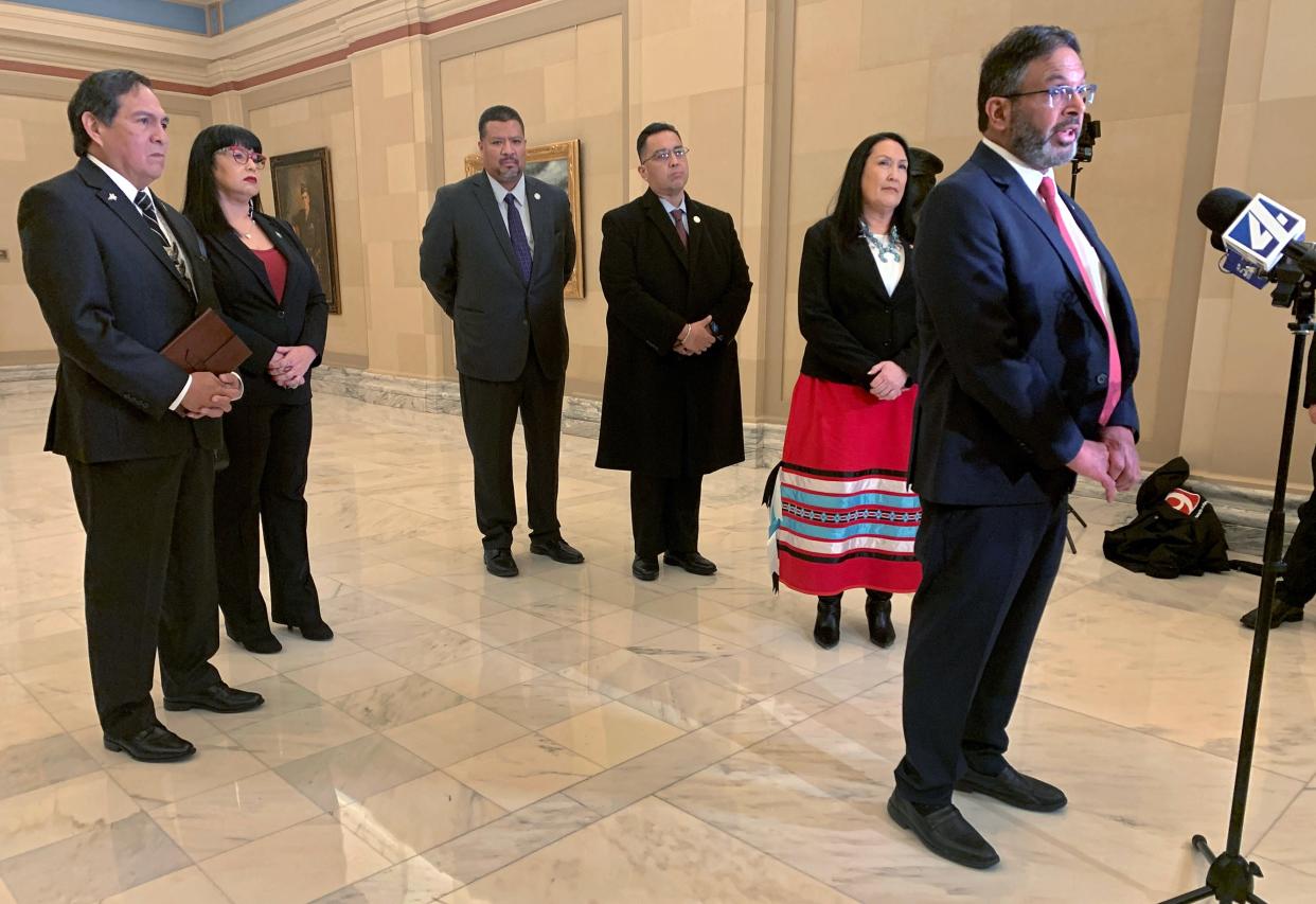 Representatives of Muscogee Nation speak at a press conference after an Oklahoma Supreme Court hearing on Wednesday. The court will rule whether the state had the right to tax Alicia Stroble, second from left, a Muscogee (Creek) citizen and employee who lives on the tribe's reservation. The tribe also joined her tax appeal. Standing to the left of Stroble is Muscogee Principal Chief David Hill. Riyaz Kanji, an attorney who represented the tribe, is speaking at right.