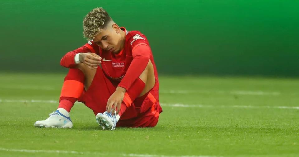 Liverpool striker Roberto Firmino unties his laces Credit: PA Images