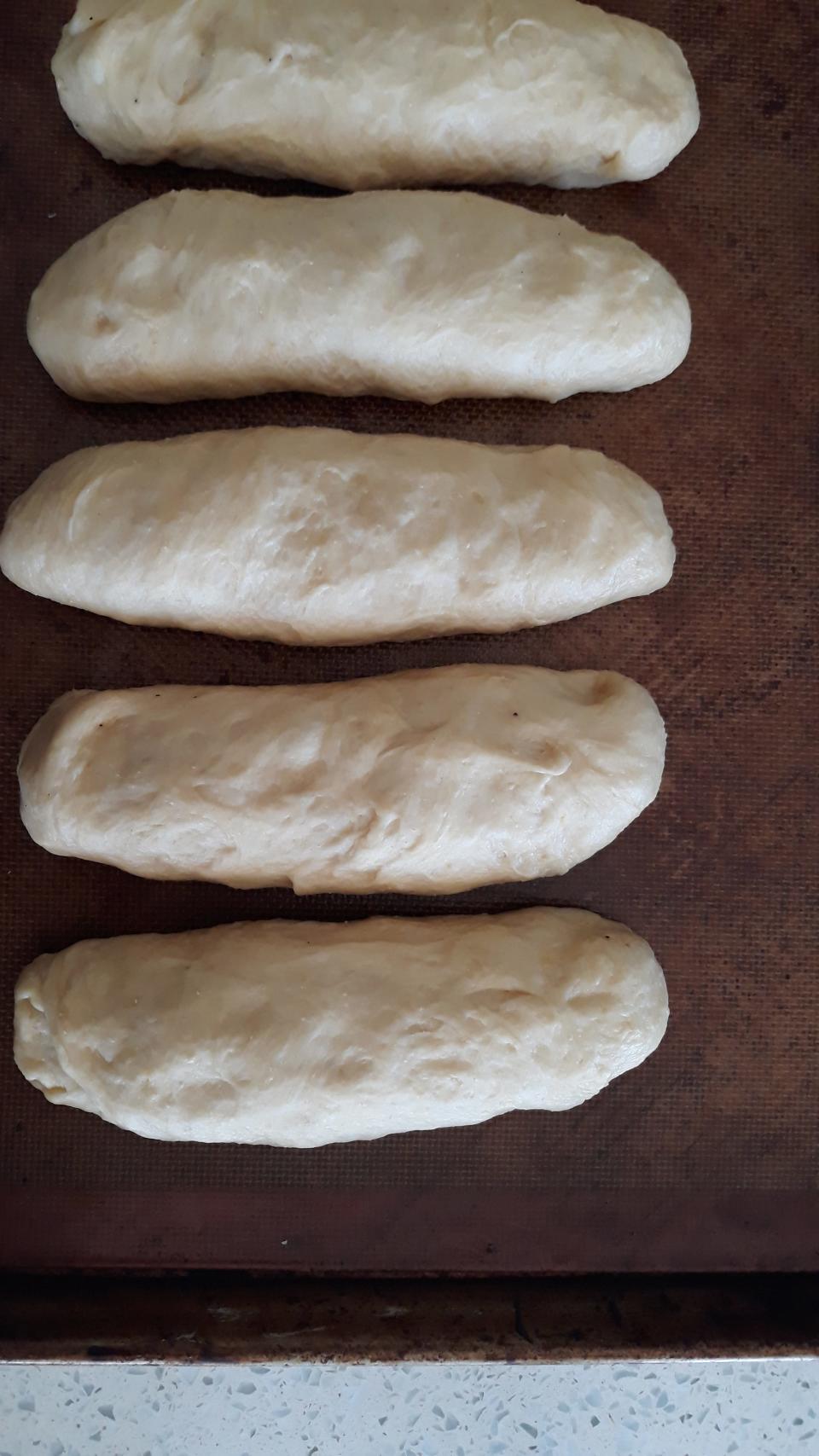 Shape your doggo buns into bun shape before a second proof.