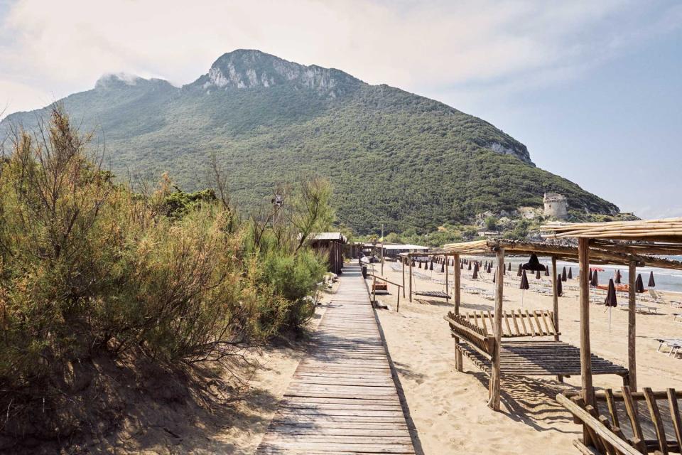 A walkway at the Saporetti beach club, in Sabaudia, Italy, with Monte Circeo in the background