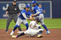 Toronto Blue Jays shortstop Bo Bichette tags out Tampa Bay Rays' Yandy Diaz (2) after he was caught in a rundown during the third inning of a baseball game Thursday, March 28, 2024, in St. Petersburg, Fla. (AP Photo/Chris O'Meara)