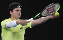 Canada's Milos Raonic prepares to serve to Serbia's Novak Djokovic during their quarterfinal match at the Australian Open tennis championship in Melbourne, Australia, Tuesday, Jan. 28, 2020. (AP Photo/Andy Brownbill)