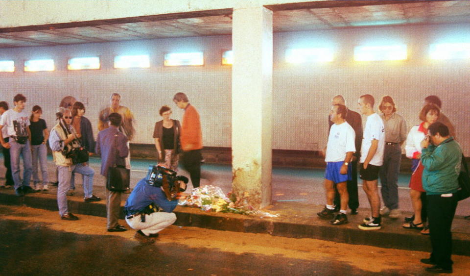 A cameraman films the point of the fatal car accident in Paris which killed Diana, Princess of Wales, and Dodi al-Fayed. Bunches of flowers have been laid down in their memory.<span class="copyright">Jacques Demarthon—AFP via Getty Images</span>