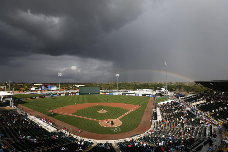 A rainbow forms beyond Hammond stadium during a spring training baseball game between the Minnesota Twins and the Pittsburgh Pirates in Fort Myers, Fla., Tuesday, Feb. 26, 2019. (AP Photo/Gerald Herbert)