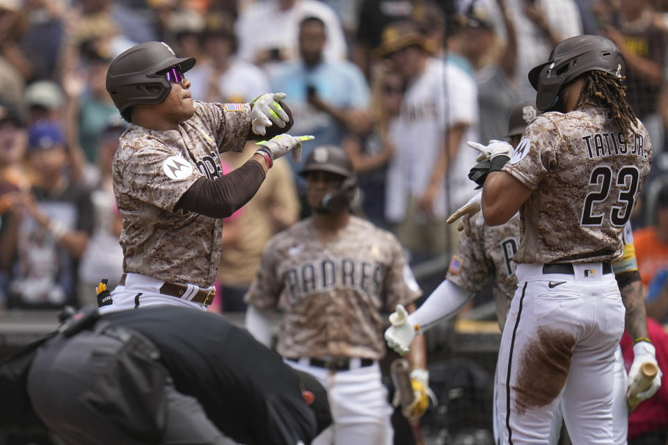 San Diego Padres' Juan Soto, left, celebrates with teammate Fernando Tatis Jr. after hitting a two-run home run during the first inning of a baseball game against the San Francisco Giants, Sunday, Sept. 3, 2023, in San Diego. (AP Photo/Gregory Bull)