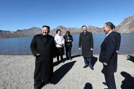 South Korean President Moon Jae-in and North Korean leader Kim Jong Un talk next to the Heaven Lake of Mt. Paektu, North Korea, September 20, 2018. Pyeongyang Press Corps/Pool via REUTERS