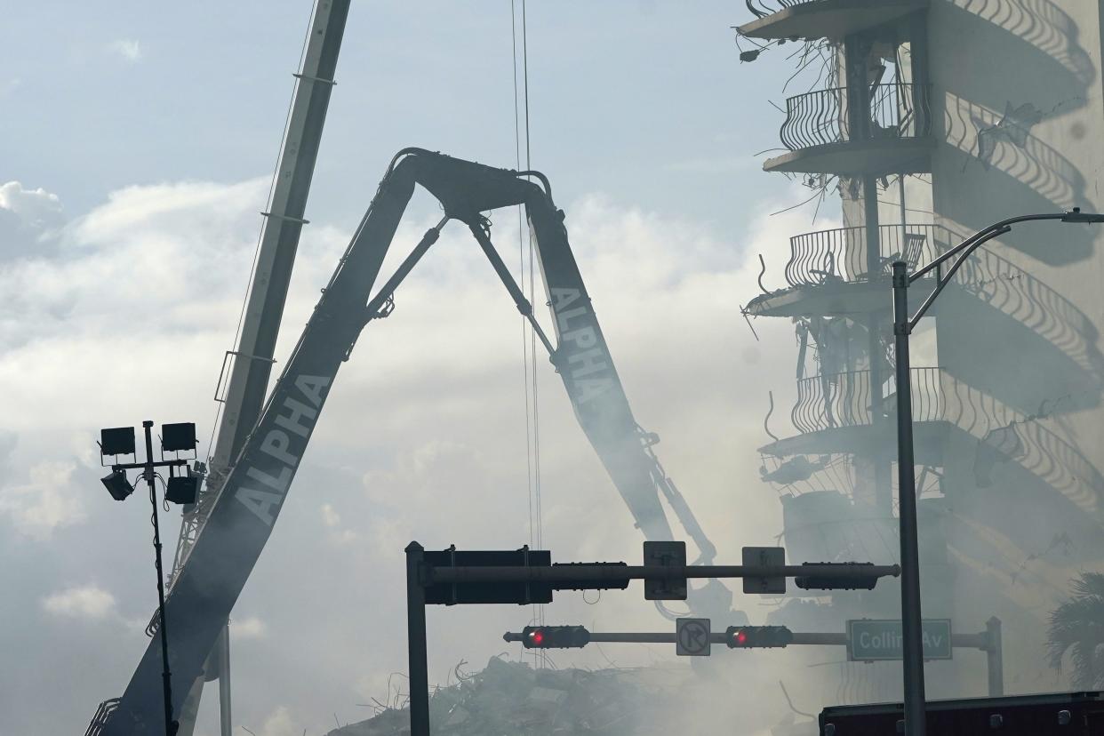 A crane works at the site of the Champlain Towers South Condo building, Saturday, June 26, 2021, in the Surfside area of Miami. The apartment building partially collapsed on Thursday.