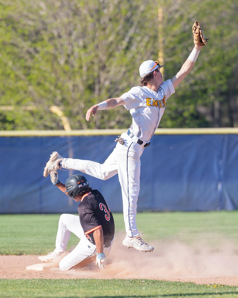 Hartland's Bobby Griffon tries to pull down an errant throw as Brighton's Alex Larson slides into second base Wednesday, May 1, 2024.