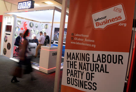 An attendee walks past the Labour Business stand at the Labour Party Conference venue in Brighton, Britain, September 26, 2017. REUTERS/Toby Melville