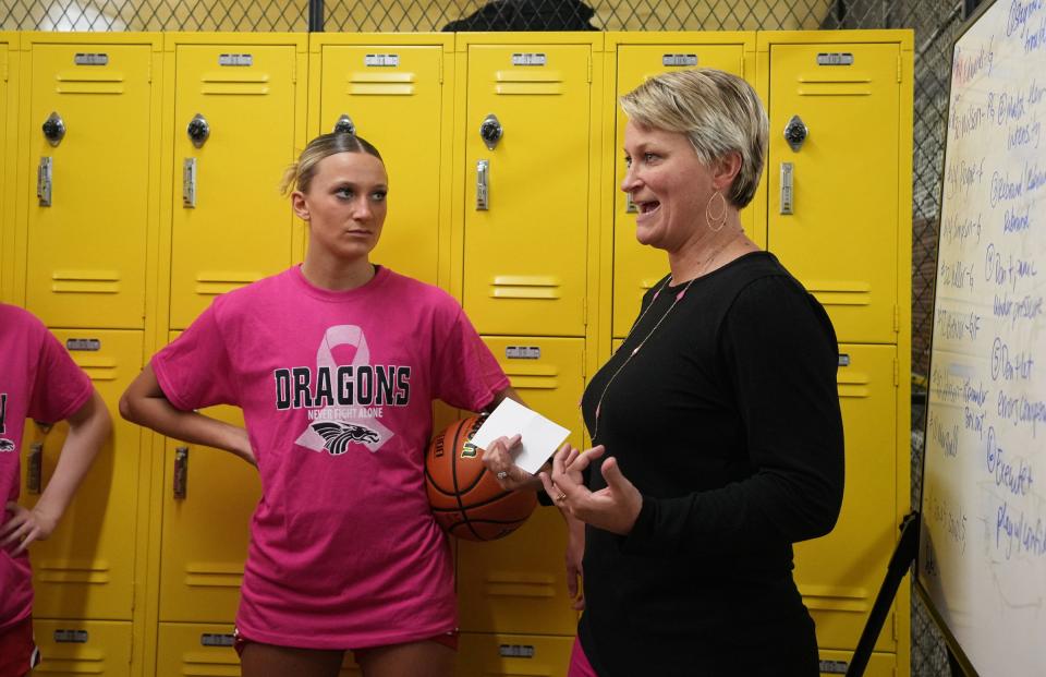 New Palestine head coach Sarah Gizzi (from right) gives direction to Isabella Gizzi and her teammates before a game against Shelbyville on Tuesday, Dec. 6, 2022, at Shelbyville High School. Isabella recently became the New Palestine girls basketball scoring leader, surpassing the record her mother Sarah set in the 1990s. 