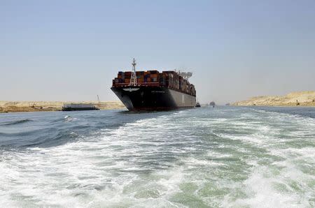 A cargo ship is seen crossing through the New Suez Canal, Ismailia, Egypt, July 25, 2015. REUTERS/Stringer