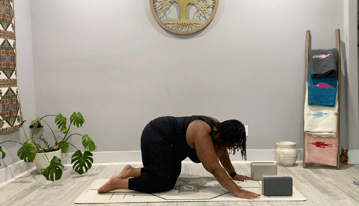 Woman kneeling on her mat doing a 15-minute yoga practice with hip circles