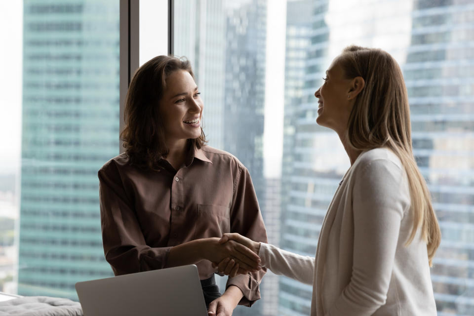 women shaking hands in an office