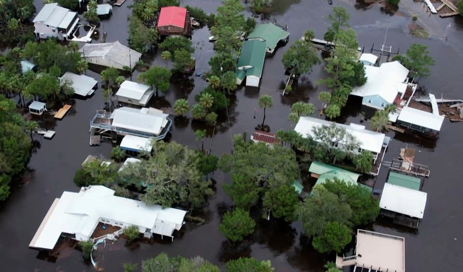 This aerial photo shows homes surrounded by floodwaters in Steinhatchee, Fla., Wednesday, Aug. 30, 2023, left behind by Hurricane Idalia. (AP Photo/Daniel Kozin)