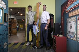 A young guest attempts to measure Sultan Kösen, the world’s tallest man, at Ripley’s Believe It or Not! Orlando. Next to them stands a figure of Robert Wadlow, the tallest man to have ever lived, measuring 8 feet 11.1 inches tall!