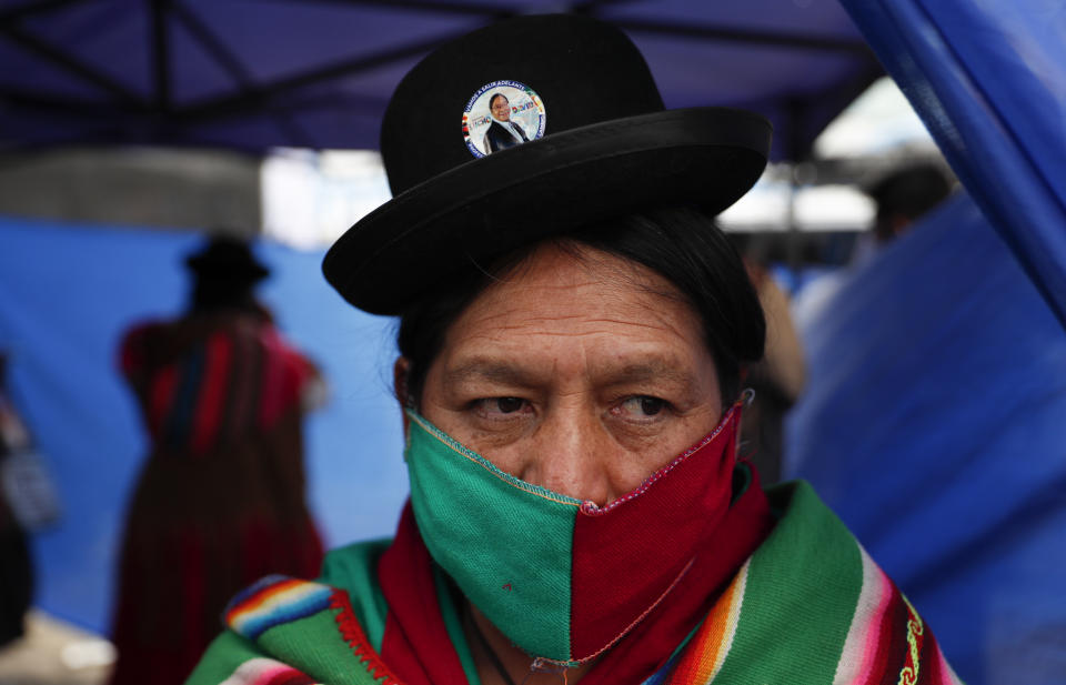 A supporter of Luis Arce, who is running for president for the Movement Towards Socialism Party (MAS) attends Arce's closing campaign rally in El Alto, Bolivia, Wednesday, Oct. 14, 2020. Elections will be held Oct. 18. (AP Photo/Juan Karita)