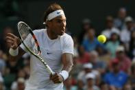 Rafael Nadal of Spain hits a shot during his match against Dustin Brown of Germany at the Wimbledon Tennis Championships in London, July 2, 2015. REUTERS/Stefan Wermuth