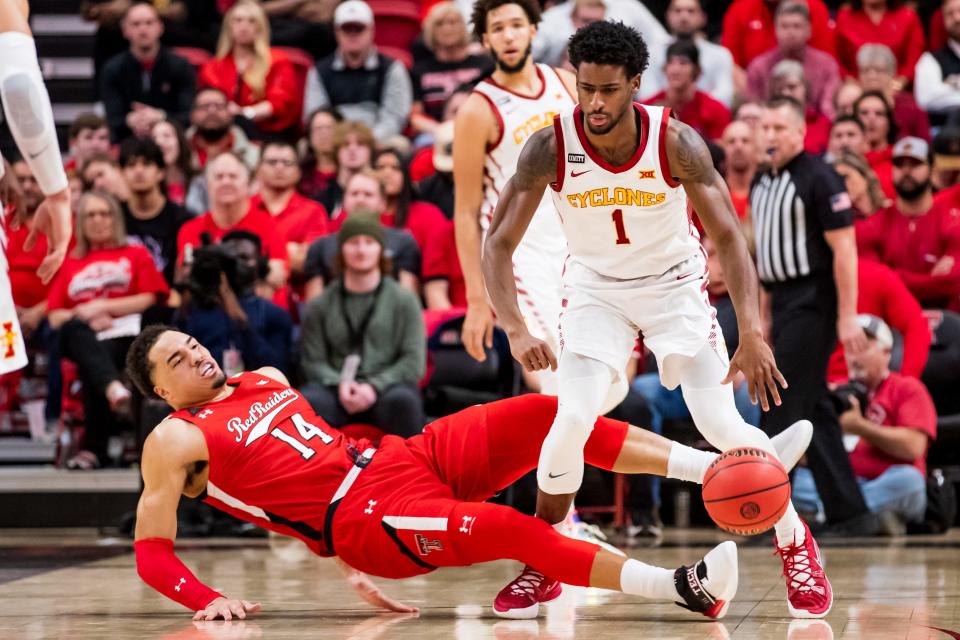 Texas Tech's Marcus Santos-Silva (14) draws a charge against Iowa State's Izaiah Brockington (1) during the first half of a Big 12 Conference game Tuesday inside United Supermarkets Arena.