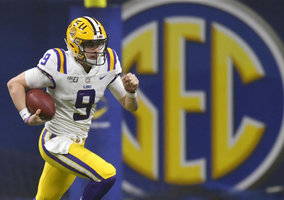 FILE - In this Dec. 7, 2019, file photo, LSU quarterback Joe Burrow (9) runs against Georgia during the second half of the Southeastern Conference championship NCAA college football game, in Atlanta. Burrow is a hero on LSU's Baton Rouge campus, but he hasn't seen much of it because he took graduate courses online. (AP Photo/Mike Stewart, File)