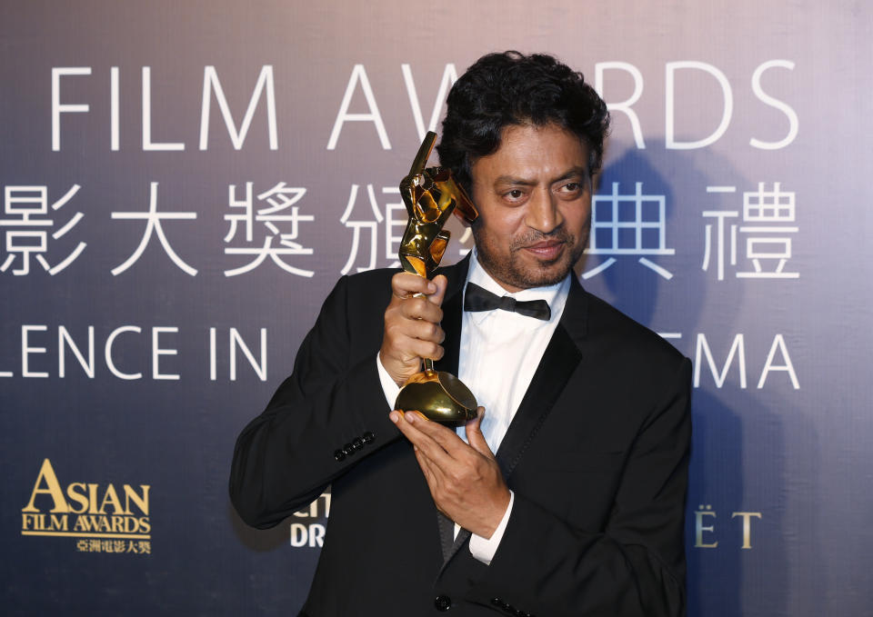 Indian actor Irrfan Khan celebrates after winning the Best Actor for his movie "The Lunchbox" of the Asian Film Awards in Macau Thursday, March 27, 2014. (AP Photo/Kin Cheung)
