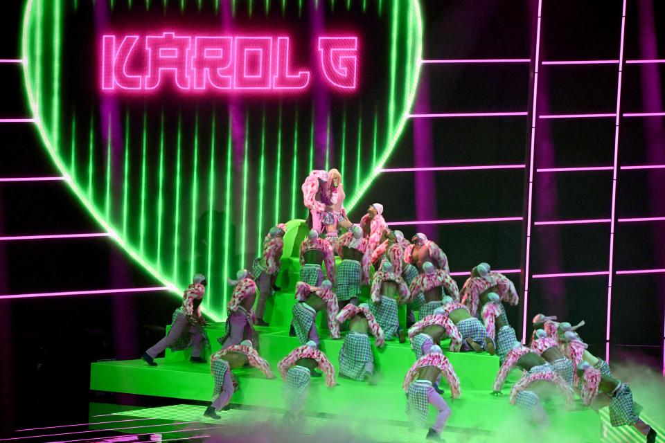 Karol G made her VMAs debut on a neon-lighted production set.