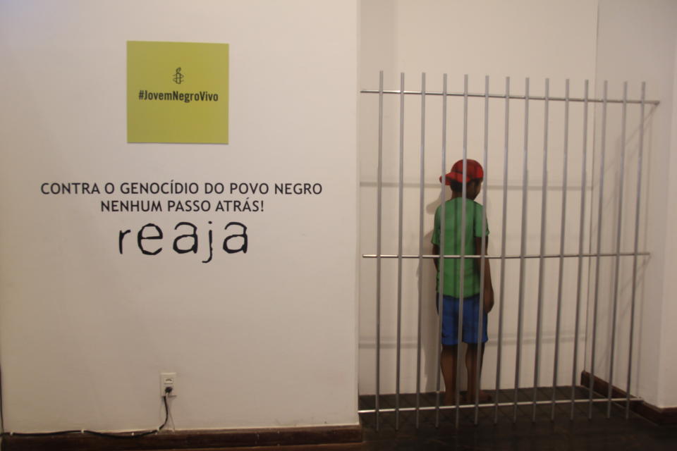 A display in the Afro-Brazilian Museum in Salvador, Bahia shows a sign of Amnesty International's campaign called Joven Negro Vivo (“Young Black Alive”).  The caption under it condemns the genocide of black youth.