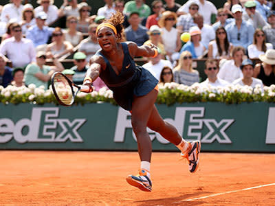 Serena Williams of United States of America stretches to play a forehand in her Women's Singles Final match against Maria Sharapova of Russia during day fourteen of French Open at Roland Garros on June 8, 2013 in Paris, France.