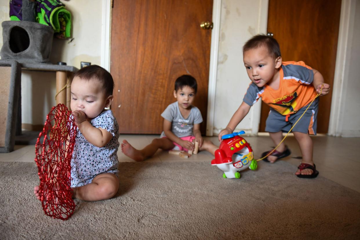 Jewel Bruner’s grandchildren play in her living room in Eagle Butte on Sept. 20, 2023.