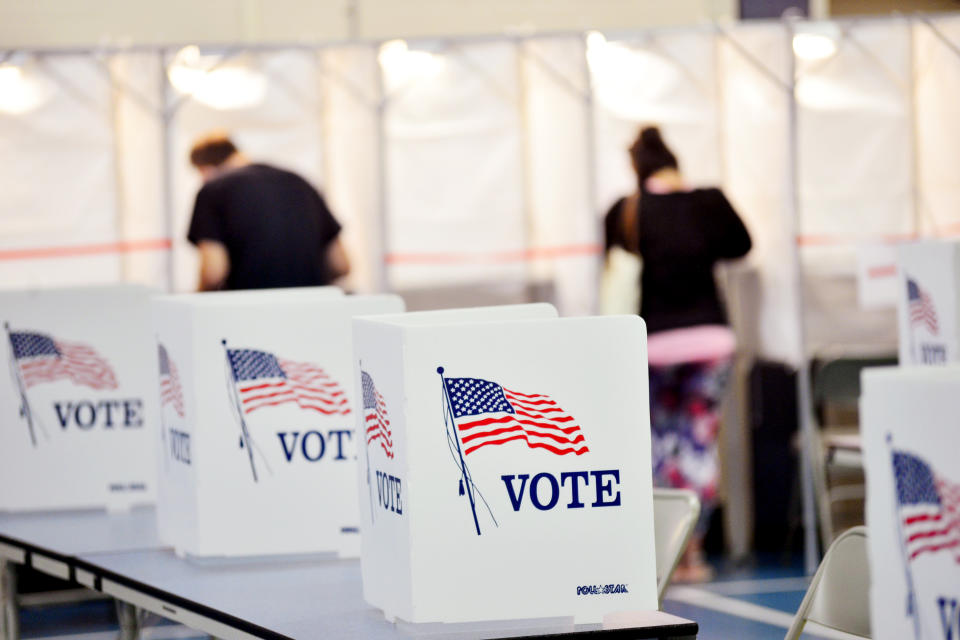 In this Sept. 8, 2020 photo, voting booths are kept socially distant at the Chesterfield, N.H. polling site. A majority of President Donald Trump’s supporters plan to cast their ballot on Election Day, while about half of Joe Biden’s backers plan to vote by mail. That's according to a new poll from The Associated Press-NORC Center for Public Affairs Research that finds 54% of voters say they will vote before polls open on Nov. 3. (Kristopher Radder/The Brattleboro Reformer via AP)