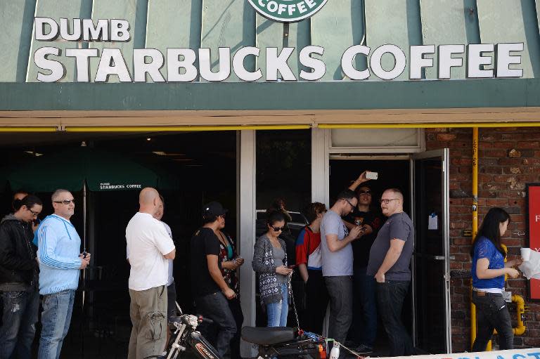 People wait in a long line to get into a coffee shop named "Dumb Starbucks" February 10, 2014, in the Los Feliz area of Los Angeles