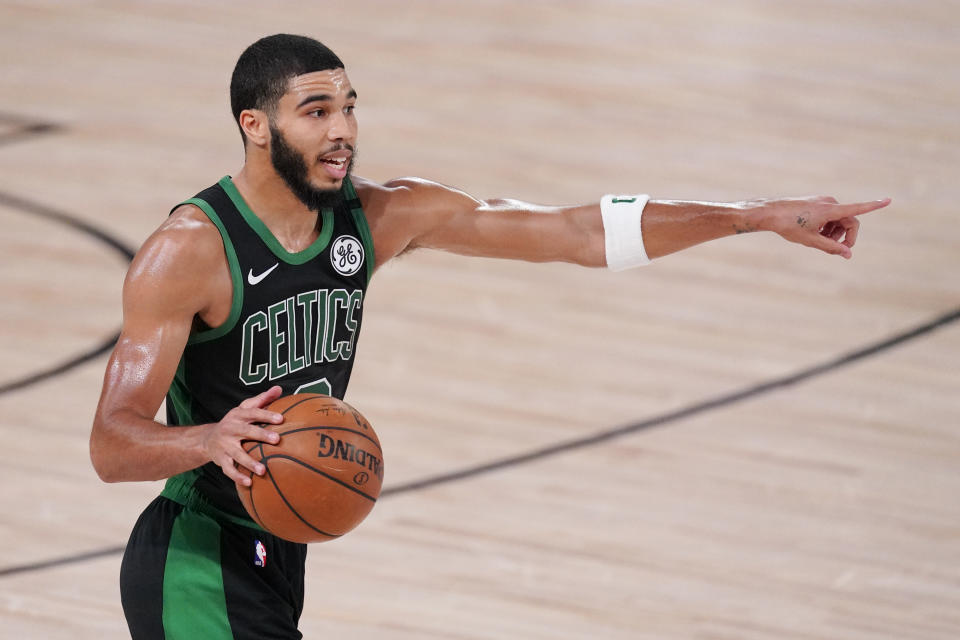 Boston Celtics' Jayson Tatum (0) directs a play during the second half of an NBA conference final playoff basketball game against the Miami Heat Friday, Sept. 25, 2020, in Lake Buena Vista, Fla. (AP Photo/Mark J. Terrill)