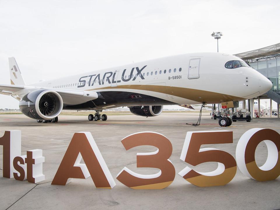 Starlux's first A350 with sign in front.