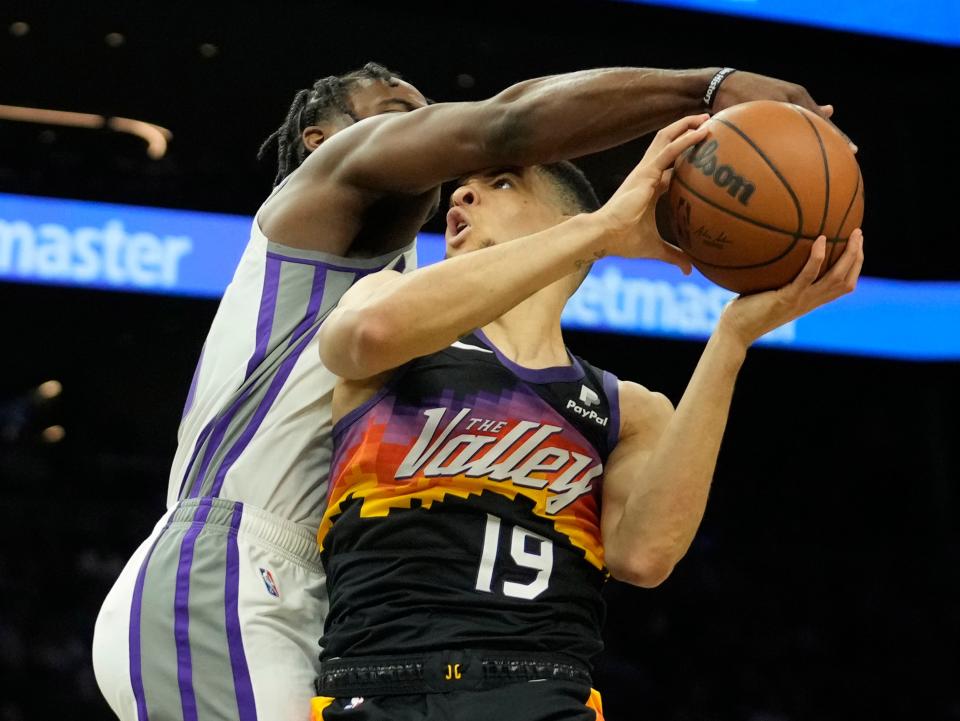 Apr 10, 2022; Phoenix, Ariz. U.S.;  Phoenix Suns forward Iffe Lundberg (19) is fouled by Sacramento Kings guard Davion Mitchell (15) during the second quarter at Footprint Center.