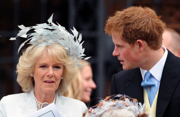 The then-Camilla, Duchess of Cornwall and Prince Harry attend the wedding of Peter Phillips and Autumn Kelly at St. George's Chapel on May 17, 2008. 