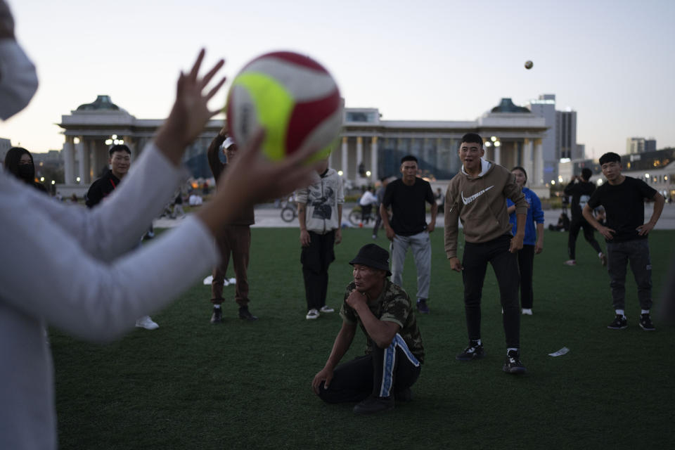 Mongolian youths play volleyball on a lawn near Sukhbaatar Square in Ulaanbaatar, Mongolia on Tuesday, Aug. 29, 2023. When Pope Francis travels to Mongolia this week, he will in some ways be completing a mission begun by the 13th century Pope Innocent IV, who dispatched emissaries east to ascertain the intentions of the rapidly expanding Mongol Empire and beseech its leaders to halt the bloodshed and convert.(AP Photo/Ng Han Guan)