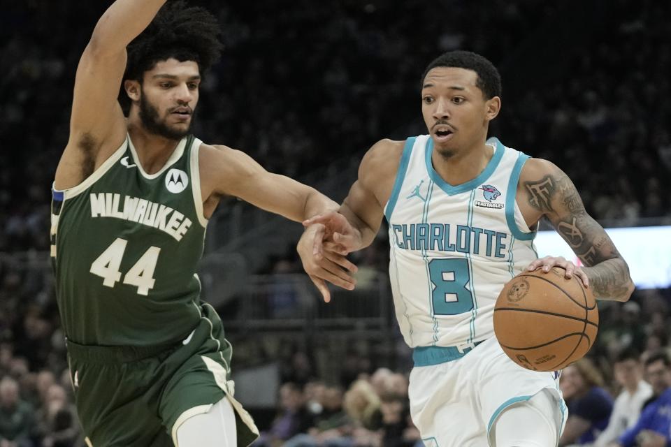 Charlotte Hornets' Nick Smith Jr. tries to get past Milwaukee Bucks' Andre Jackson Jr. during the second half of an NBA basketball game Friday, Feb. 9, 2024, in Milwaukee. (AP Photo/Morry Gash)