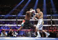 Floyd Mayweather Jr., left, trades blows with Marcos Maidana, from Argentina, in their WBC-WBA welterweight title boxing fight Saturday, May 3, 2014, in Las Vegas. (AP Photo/Eric Jamison)