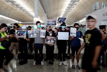 Anti-extradition bill demonstrators attend a protest at the departure hall of Hong Kong Airport