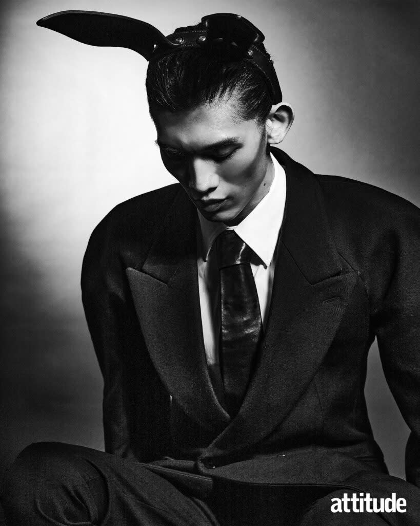 Eden wears coat, shirt, tie and trousers by Alexander McQueen, headpiece by Fleet Ilya