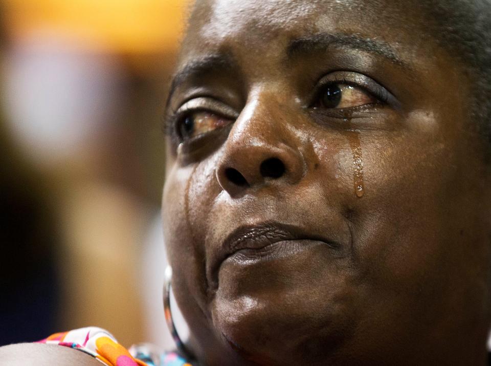 Barbara Lloyd, of Charleston, S.C., cries during the singing of "We Shall Overcome" at a memorial service for nine victims of the shooting by Dylann Roof at Emanuel AME Church, in Charleston, S.C.