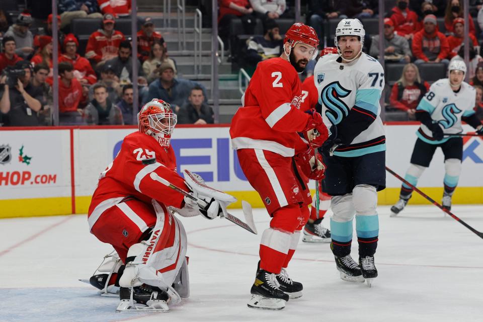 Detroit Red Wings goaltender Thomas Greiss (29) makes a save in front of defenseman Nick Leddy (2) and Seattle Kraken right wing Joonas Donskoi (72) in the first period Dec. 1, 2021 at Little Caesars Arena in Detroit.